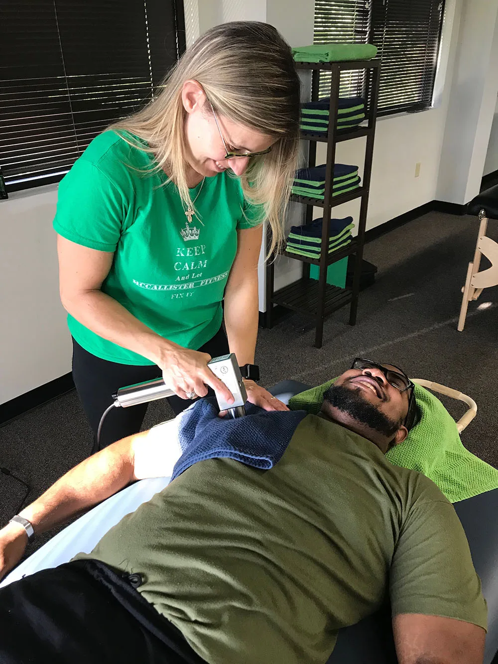 Trainer performing myofascial release on a client